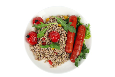 Photo of Tasty buckwheat porridge with sausages and vegetables isolated on white, top view