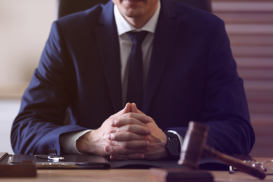 Male lawyer at table in office, closeup