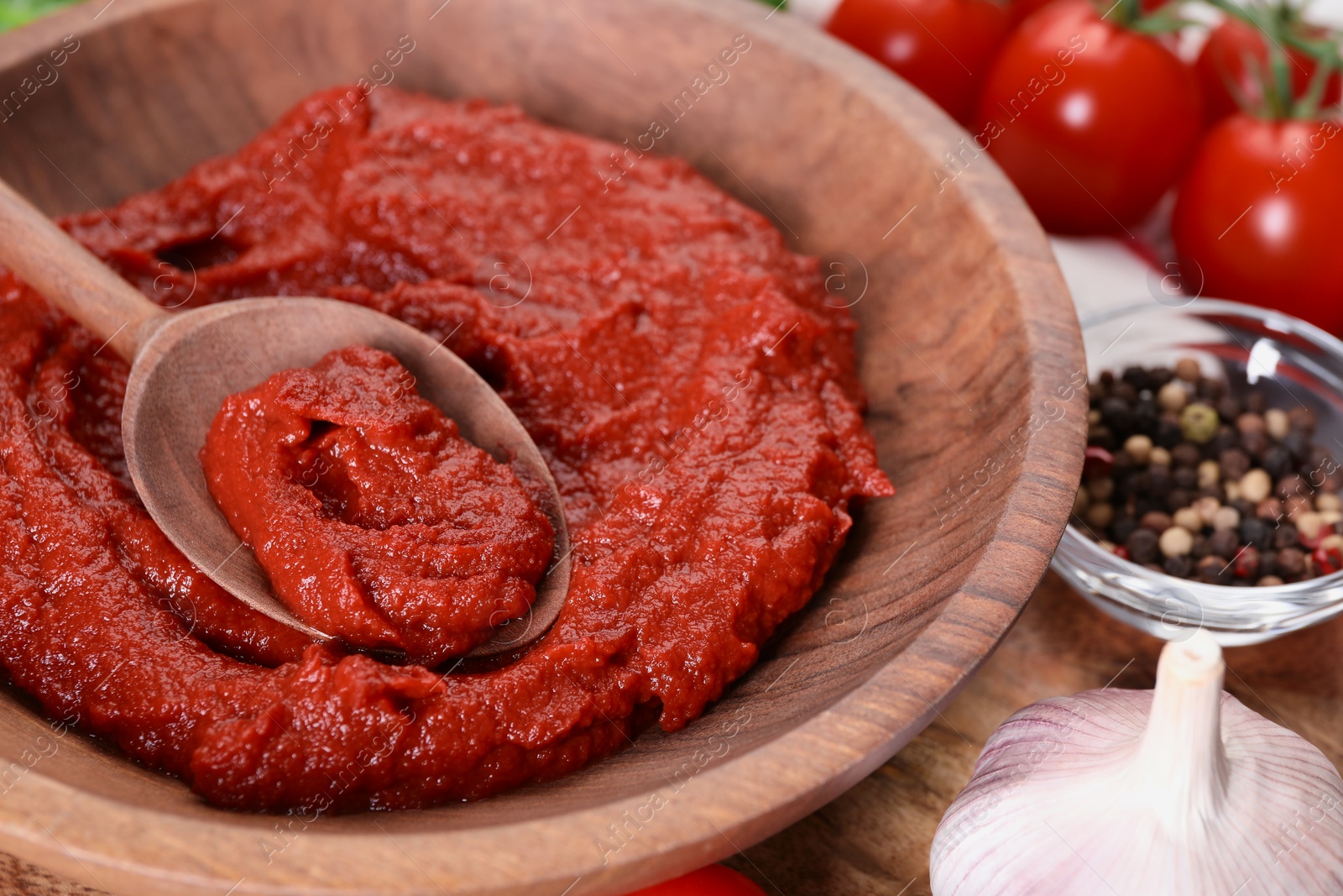 Photo of Tasty tomato paste and ingredients on table, closeup