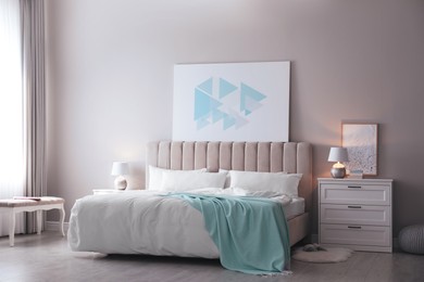 Photo of Cozy bed with soft linens in light room