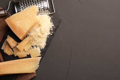 Photo of Delicious parmesan cheese on grey background, top view. Space for text