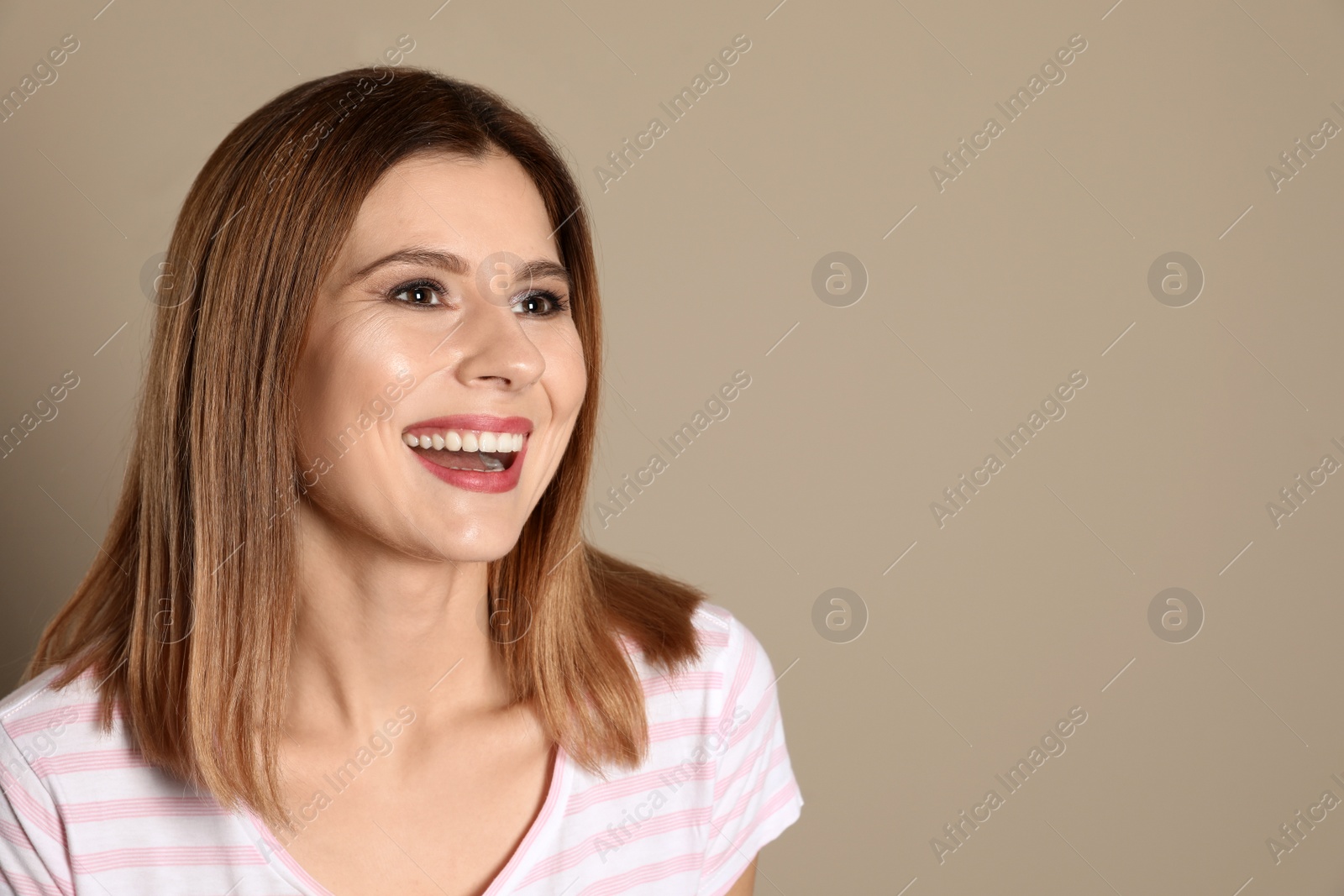 Photo of Smiling woman with perfect teeth on color background. Space for text