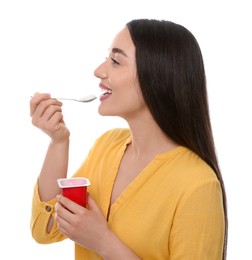 Photo of Happy woman eating tasty yogurt on white background