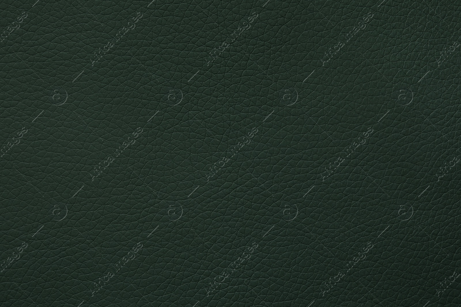 Photo of Texture of dark green leather as background, closeup