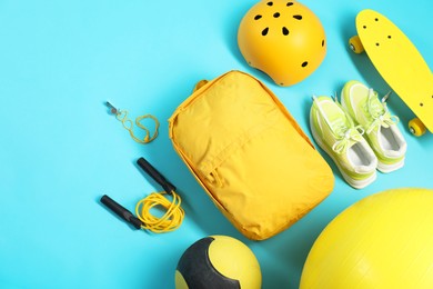 Photo of Different sports equipment on light blue background, flat lay. Space for text