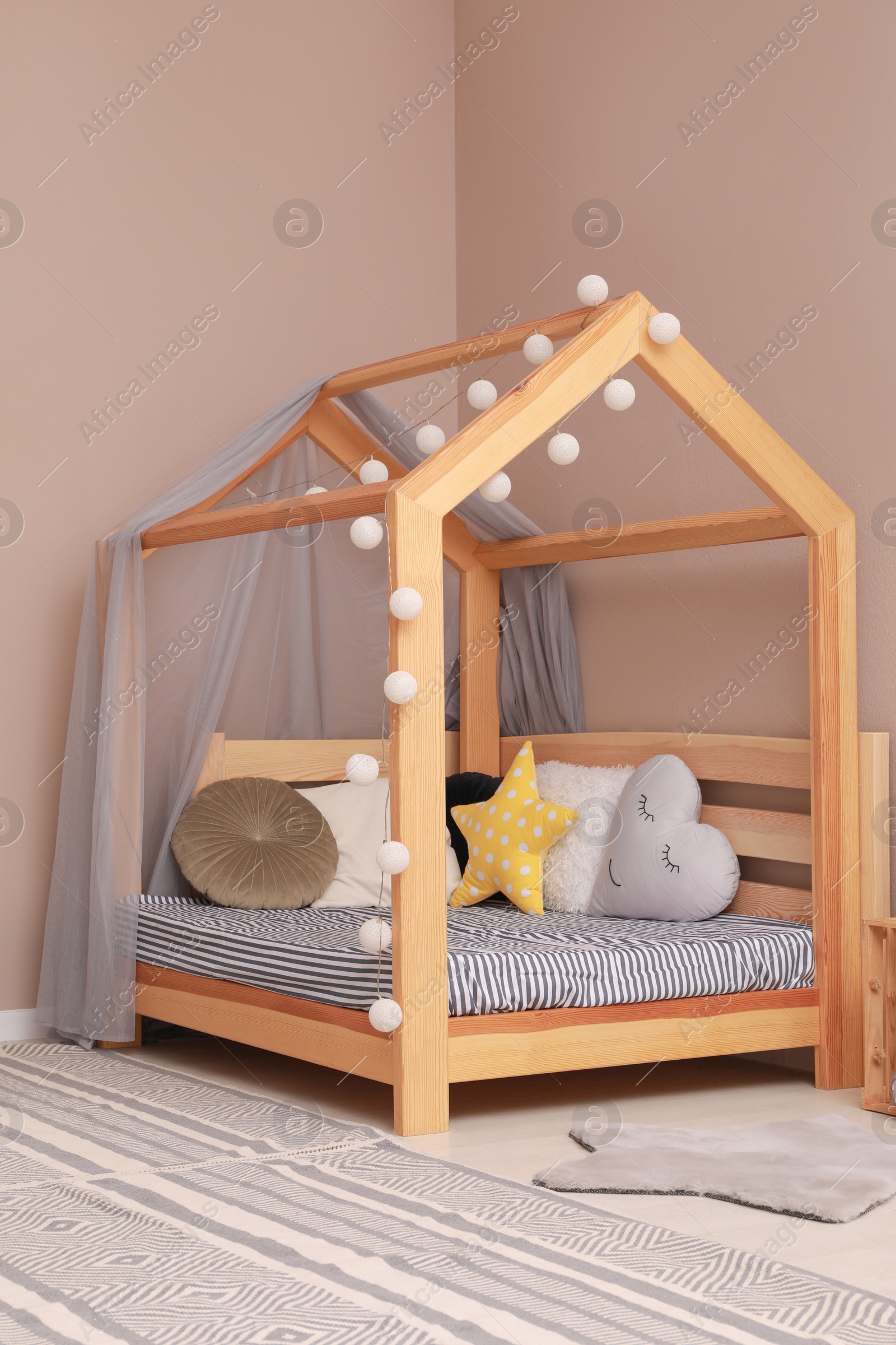 Photo of Stylish child room interior with comfortable floor bed