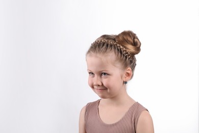 Little girl with braided hair on white background
