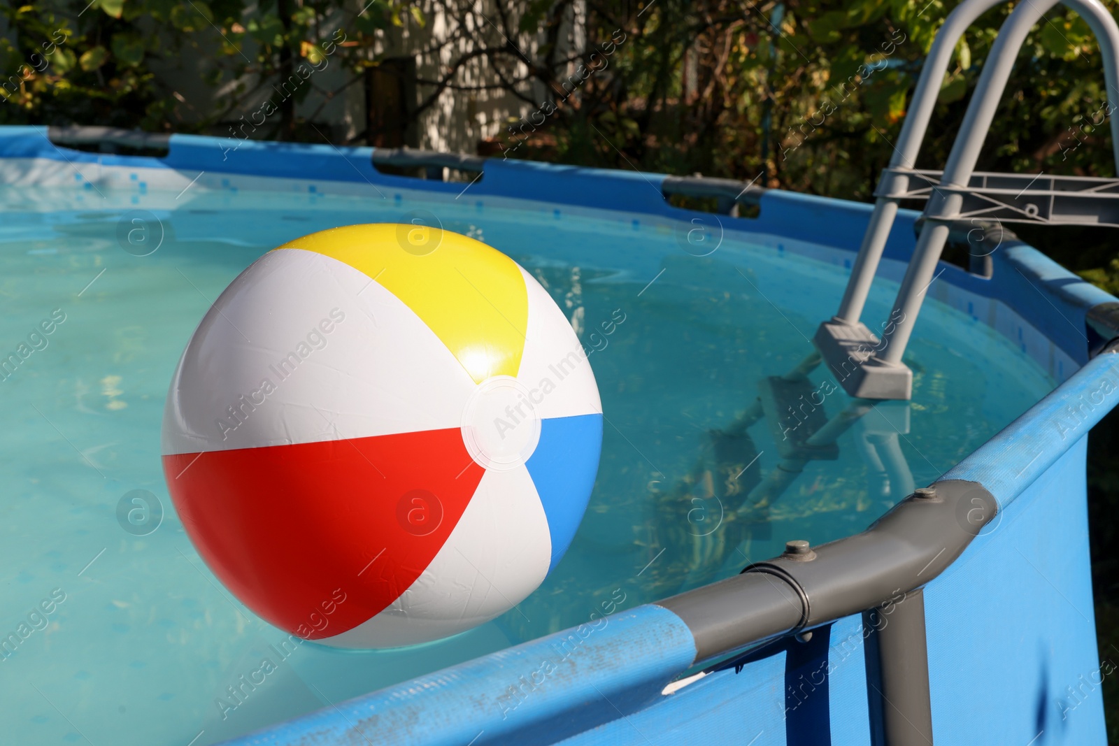 Photo of Inflatable ball on water in above ground swimming pool outdoors