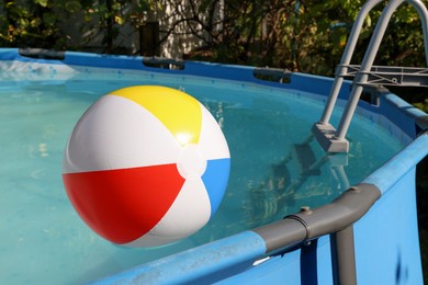 Photo of Inflatable ball on water in above ground swimming pool outdoors