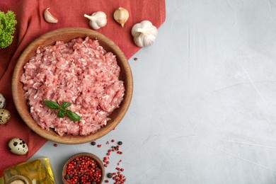 Raw chicken minced meat and ingredients on grey table, flat lay. Space for text