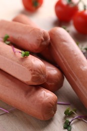 Photo of Tasty vegan sausages and products on table, closeup