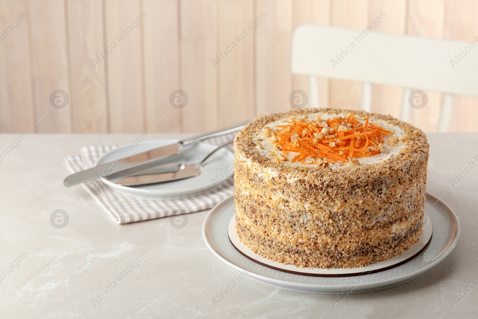 Photo of Sweet carrot cake with delicious cream on white marble table indoors, space for text