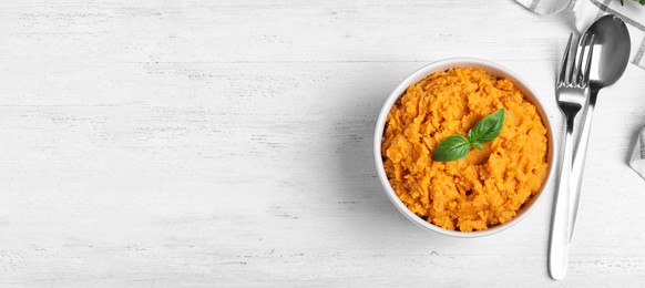 Mashed sweet potatoes on white wooden table, flat lay with space for text. Banner design