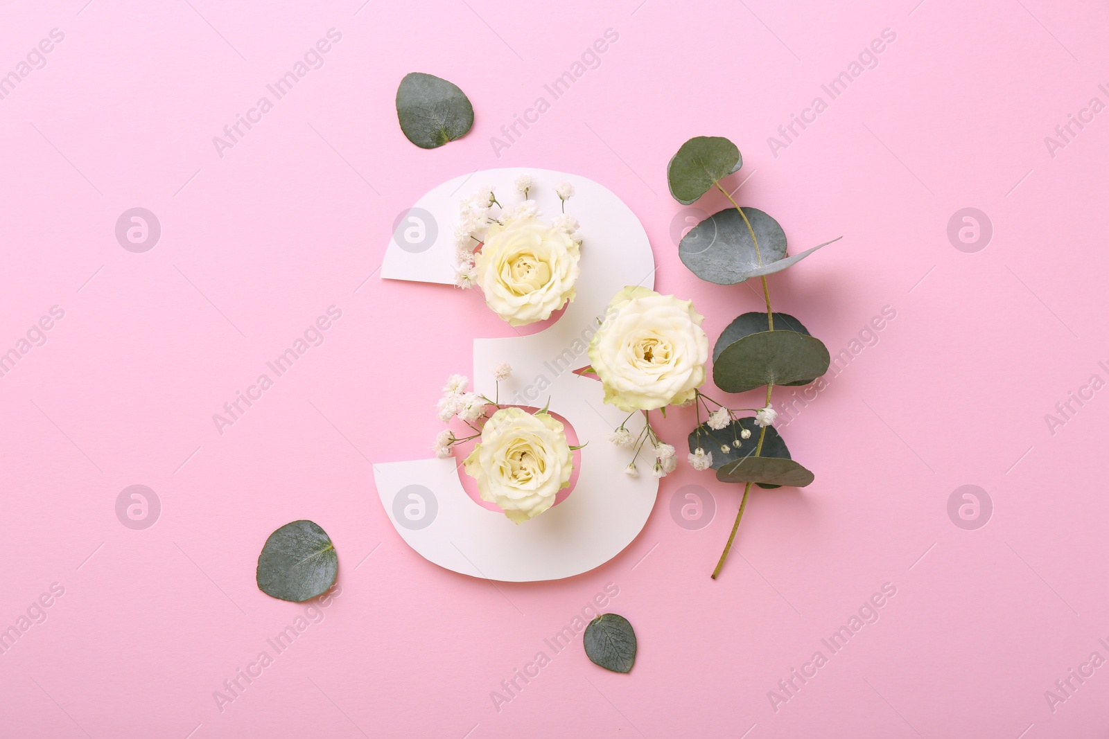 Photo of Paper number 3, eucalyptus leaves and beautiful flowers on pink background, flat lay