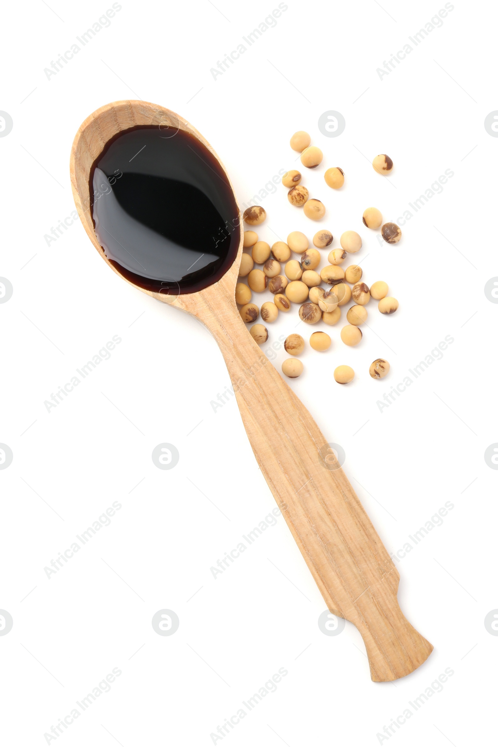 Photo of Tasty soy sauce in spoon and soybeans isolated on white, top view