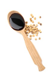 Photo of Tasty soy sauce in spoon and soybeans isolated on white, top view