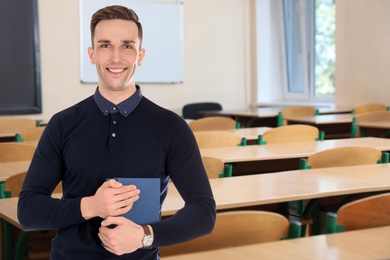 Young teacher waiting for students in classroom