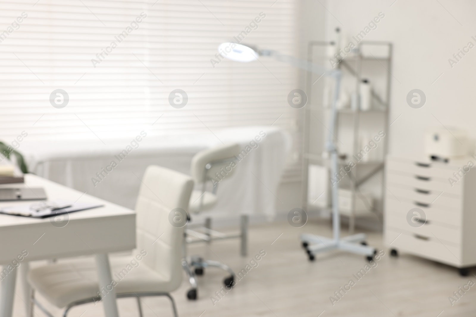 Photo of Blurred view of dermatologist's office with examination table