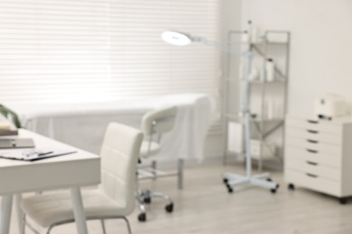 Blurred view of dermatologist's office with examination table