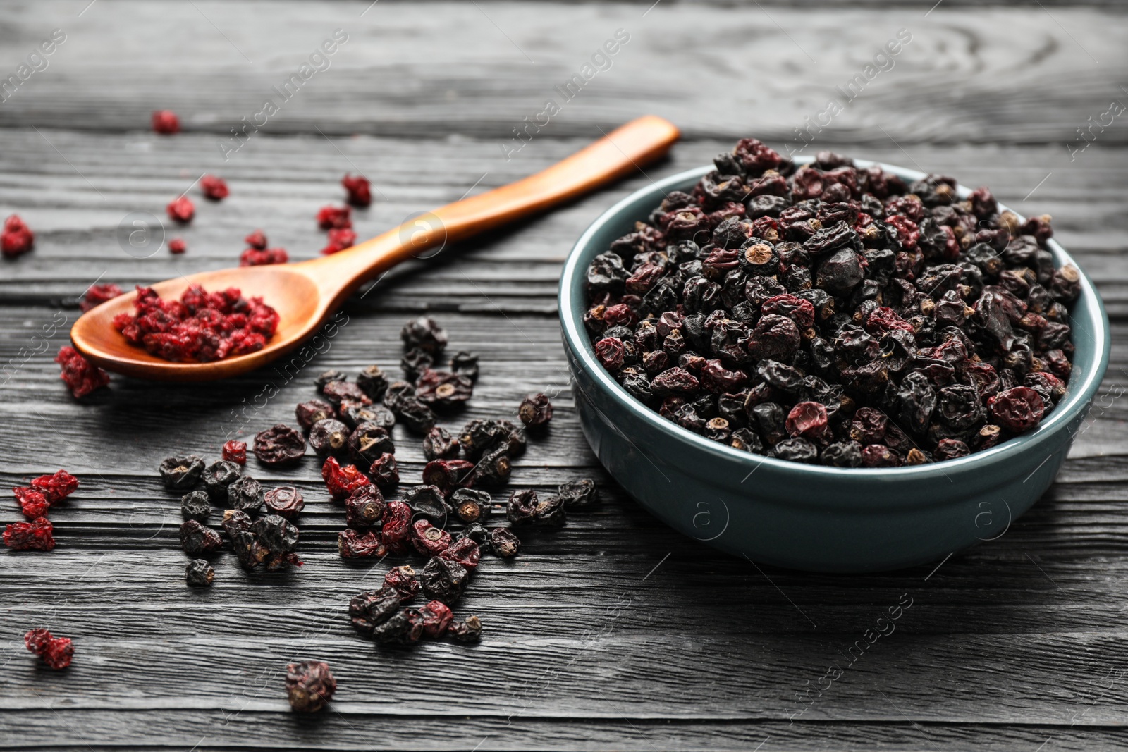 Photo of Dried black and red currant berries on wooden table