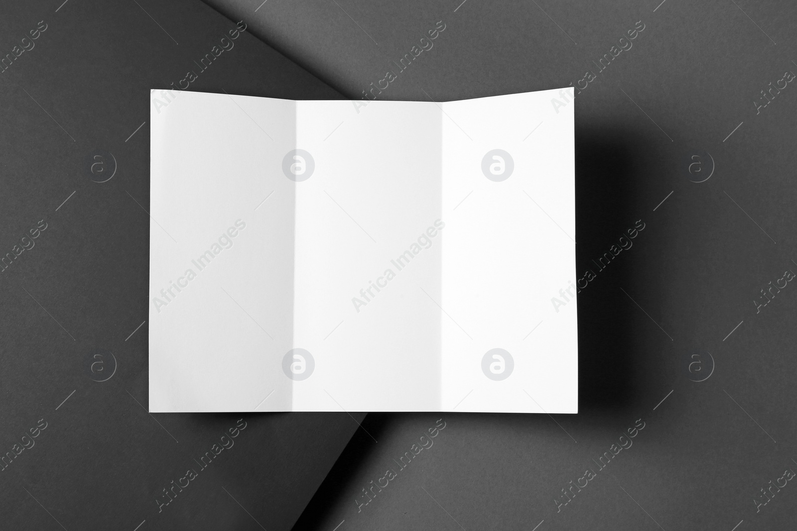 Photo of Empty flyer on dark background. Mockup for design