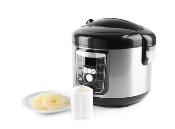 Photo of Multi cooker with yogurt and pineapple slices isolated on white
