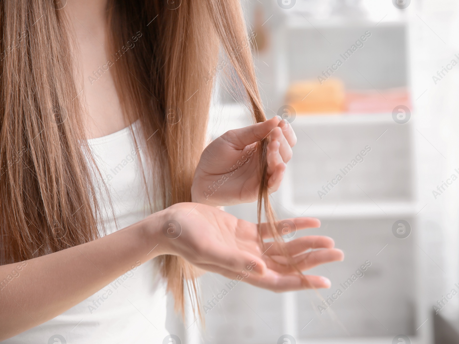 Photo of Young woman with beautiful long hair at home