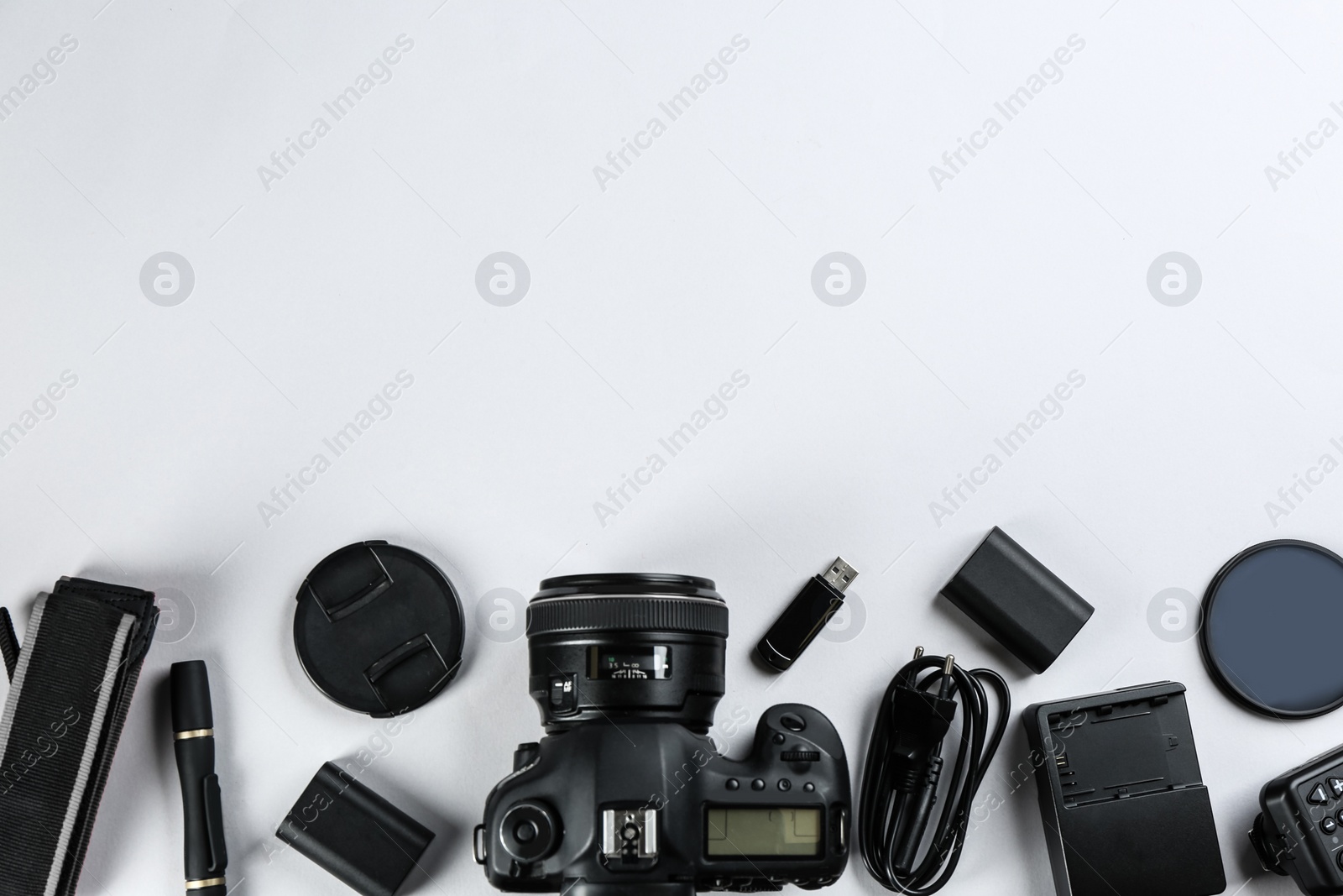 Photo of Flat lay composition with equipment for professional photographer on white background. Space for text