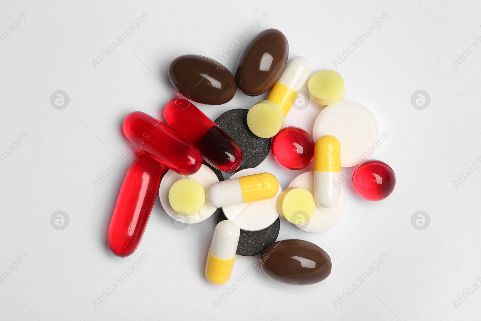 Photo of Different pills on white background, top view