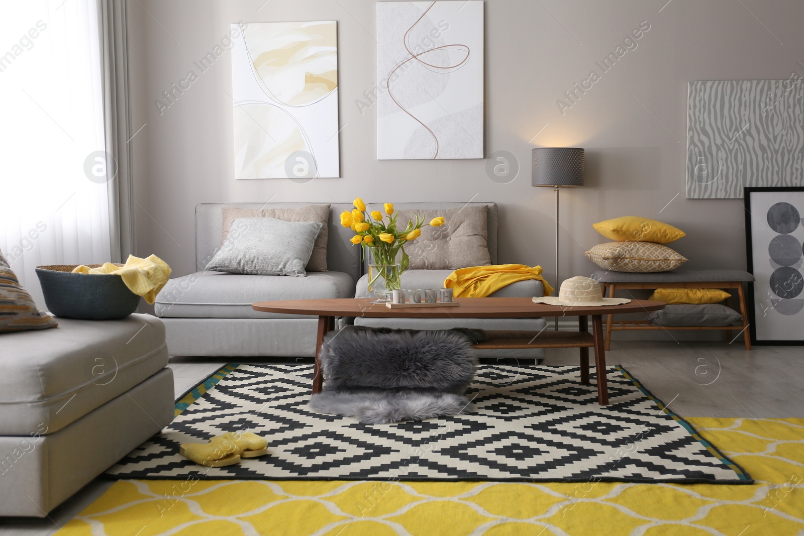 Photo of Stylish living room interior with comfortable sofa. Interior design in grey and yellow colors