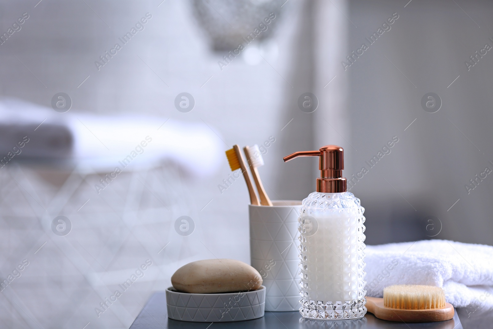 Photo of Composition with soap and toiletries on table against blurred background. Space for text