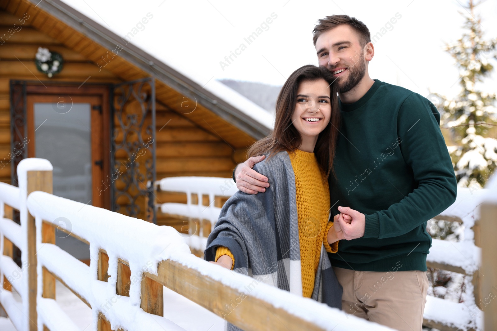 Photo of Lovely couple spending time together on snowy day. Winter vacation