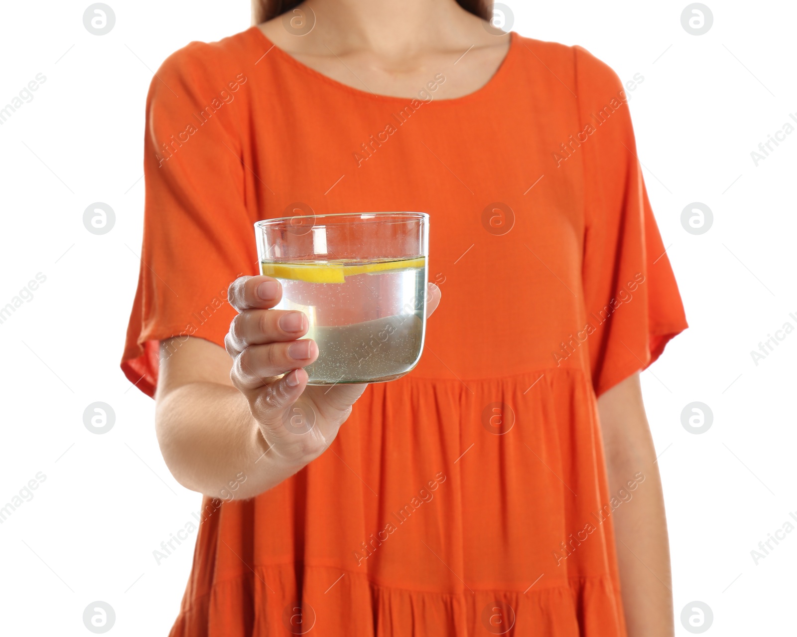 Photo of Young woman with glass of lemon water on white background, closeup