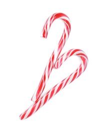 Photo of Sweet Christmas candy canes on white background, top view