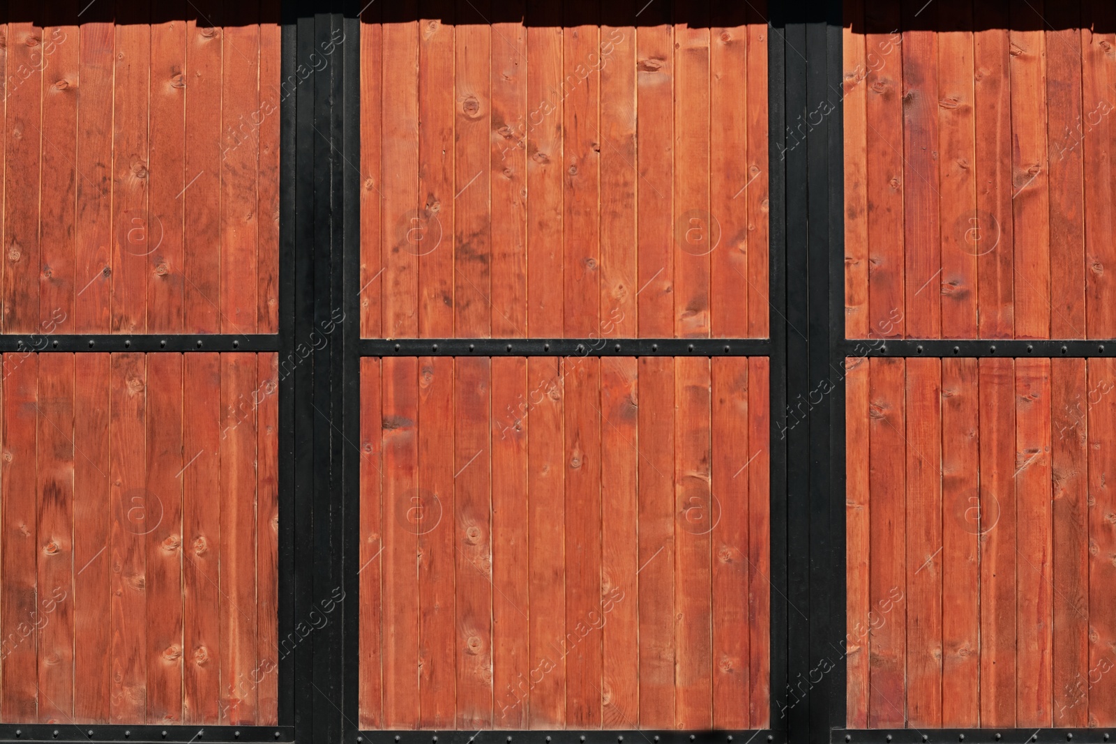 Photo of Metal and wooden fence outdoors on sunny day