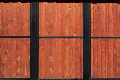 Photo of Metal and wooden fence outdoors on sunny day