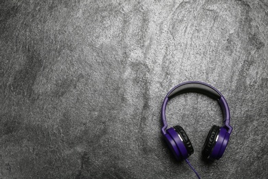 Photo of Stylish headphones on grey background, top view. Space for text