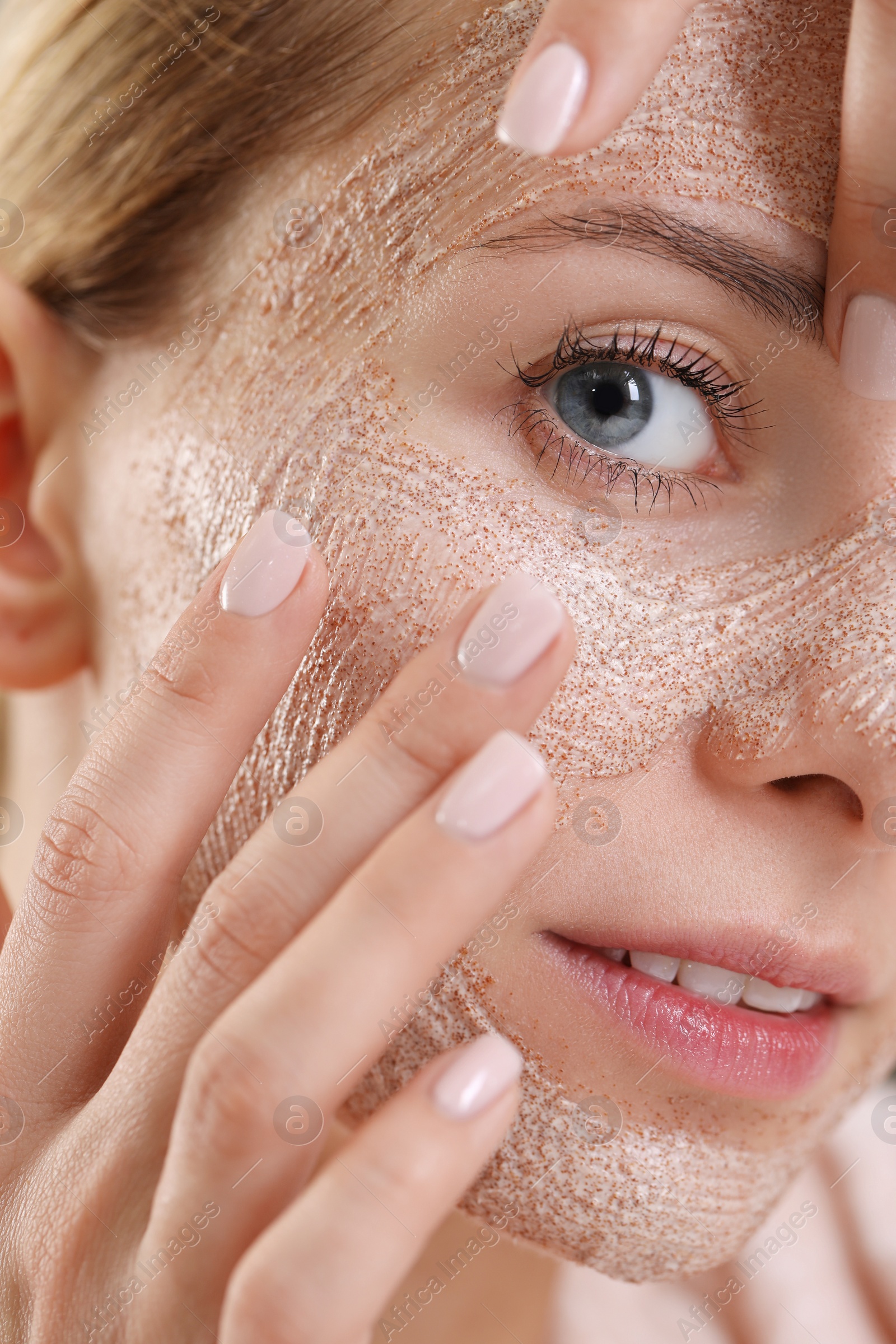 Photo of Woman applying face mask, closeup. Spa treatments