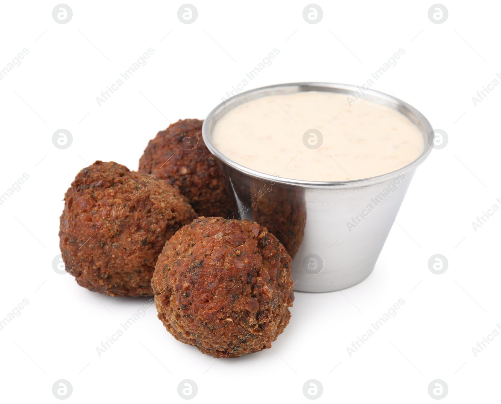 Photo of Delicious falafel balls and sauce isolated on white