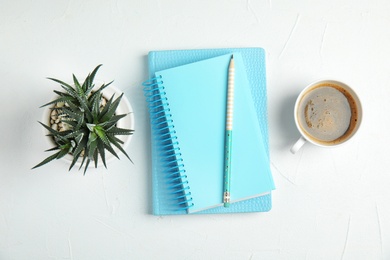 Flat lay composition with notebooks and coffee on white background