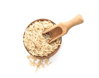 Bowl and scoop with raw unpolished rice on white background, top view