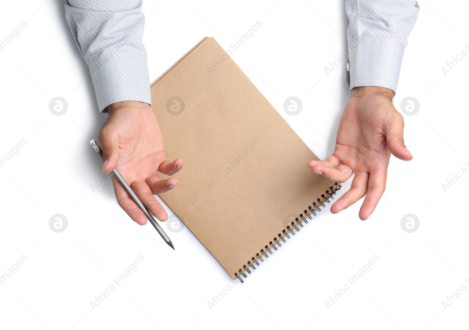 Photo of Man with pencil and notepad on white background, top view. Closeup of hands