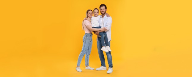 Image of Happy family with child on orange background. Banner design