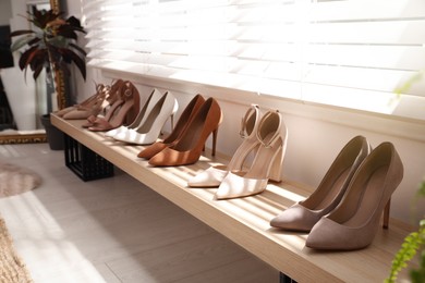 Photo of Collection of beautiful shoes in dressing room