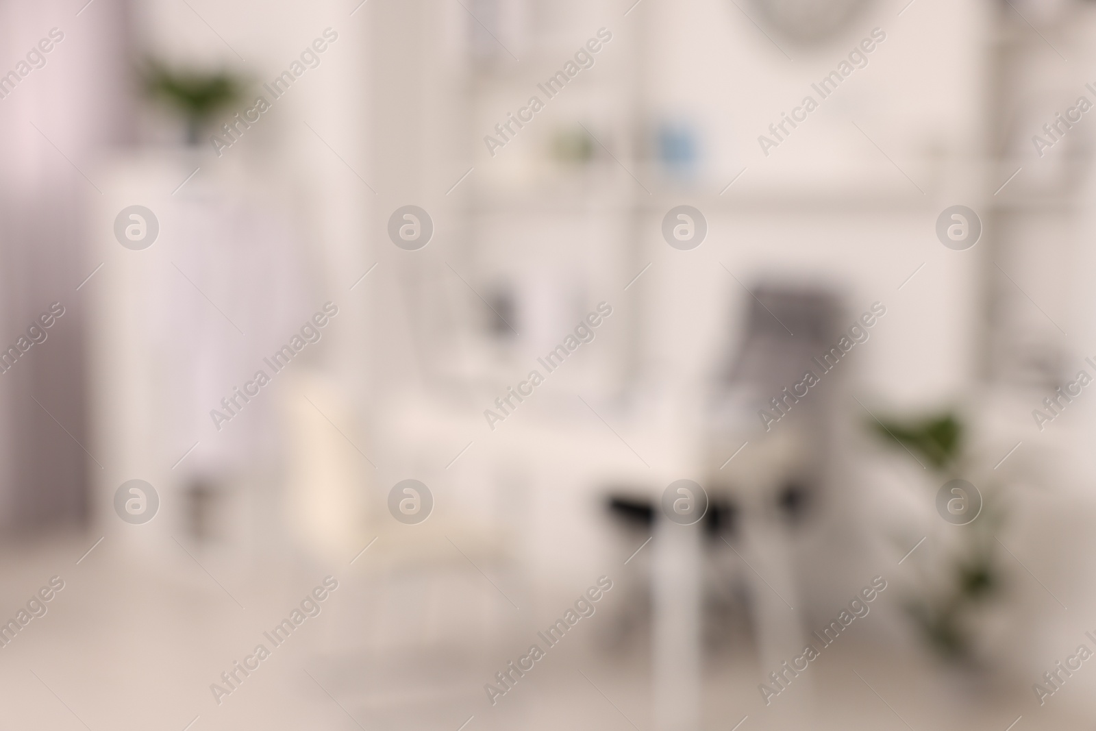 Photo of Blurred view of medical office interior with doctor's workplace