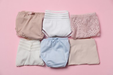 Photo of Stylish folded women's underwear on pink background, flat lay