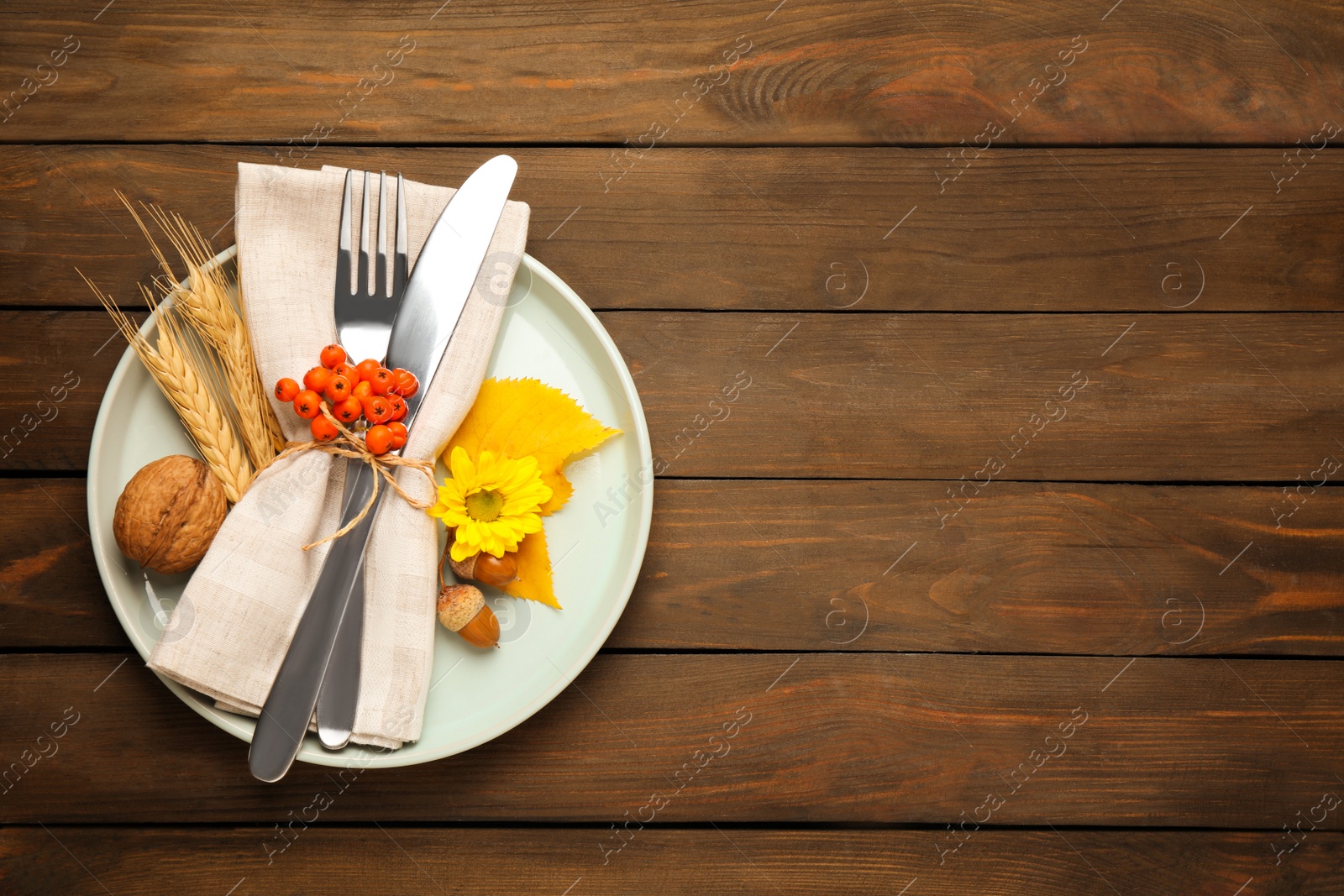 Photo of Top view of seasonal table setting with autumn items on wooden background, space for text. Thanksgiving Day