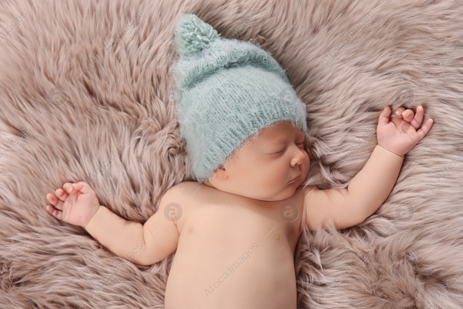 Photo of Cute newborn baby sleeping on fluffy blanket, top view