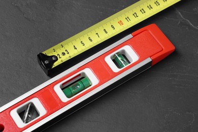 Photo of Building level and tape measure on black table