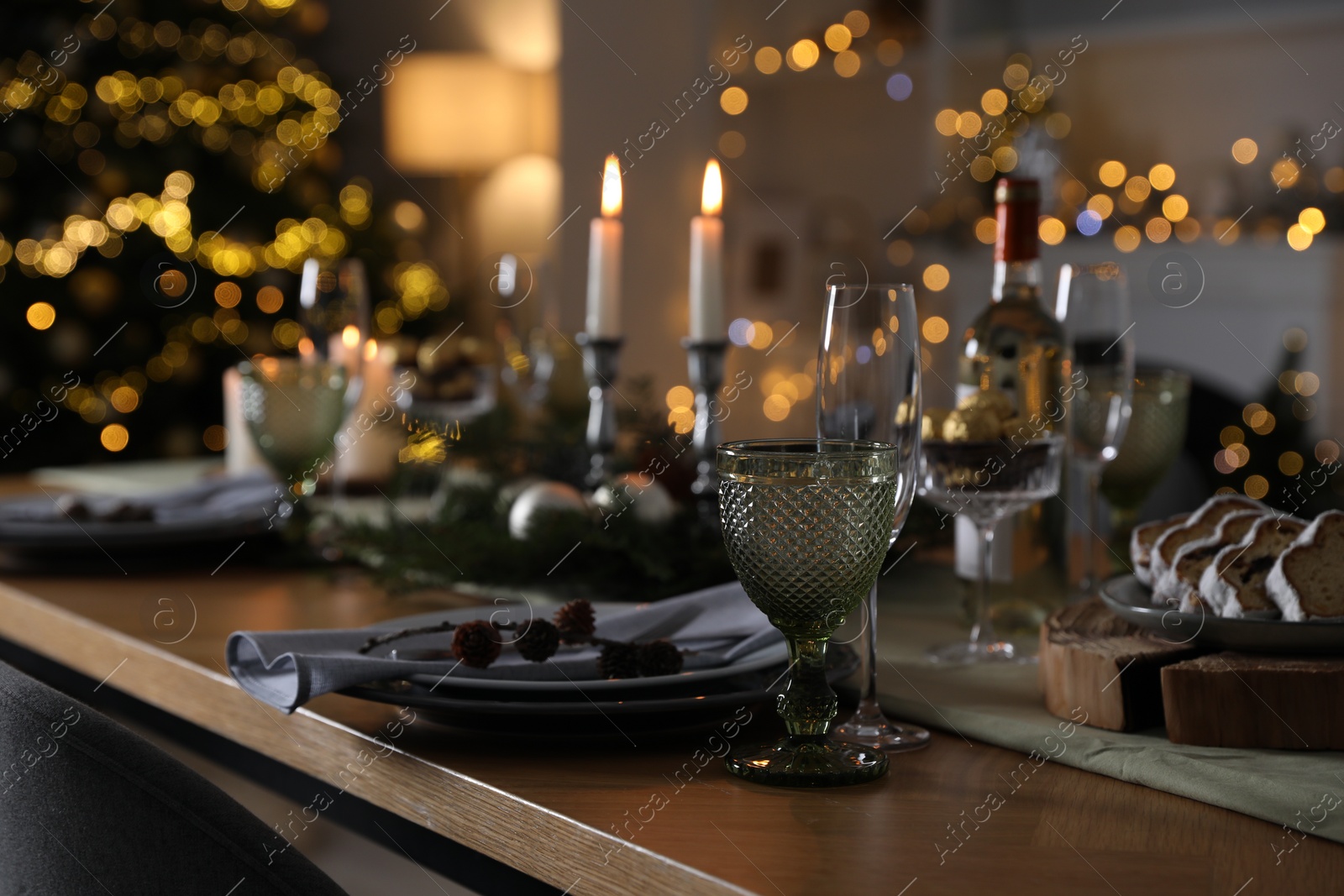 Photo of Christmas table setting with festive decor and dishware indoors